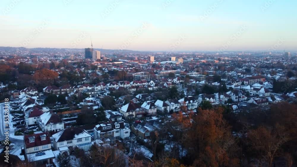 Drone shot flying over town in London suburbs with white snow in winter Drone shot flying over town in London suburbs with white snow in winter