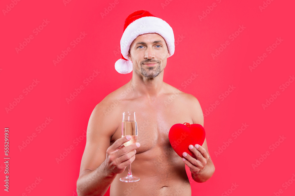 smiling xmas man isolated on red background. man hold heart at xmas in studio. xmas heart smiling xmas man isolated on red background. man hold heart at xmas in studio. xmas heart
