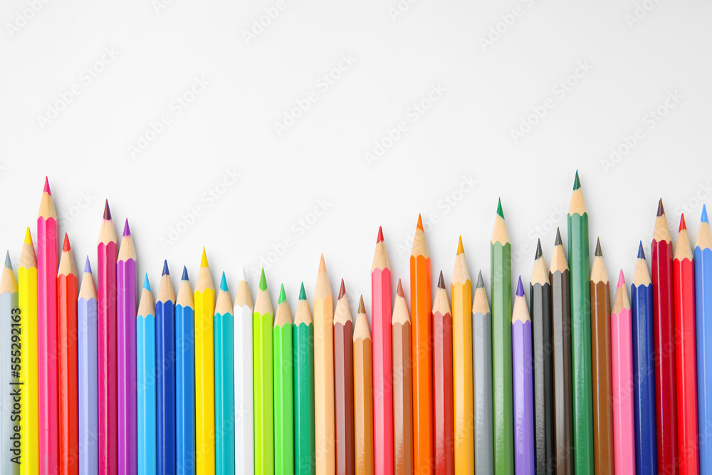Many colorful wooden pencils on white background, flat lay. Space for text Many colorful wooden pencils on white background, flat lay. Space for text