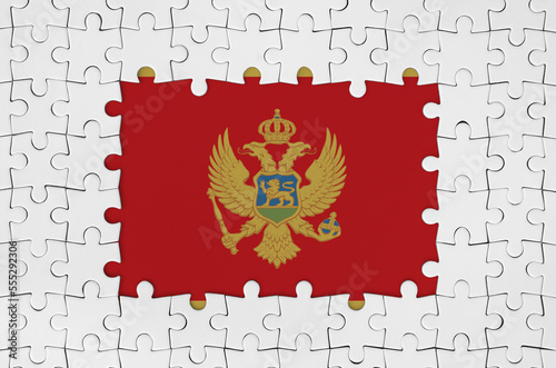 Montenegro flag in frame of white puzzle pieces with missing central parts photo