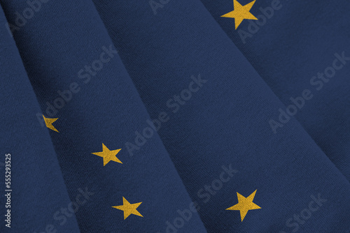 Alaska US state flag with big folds waving close up under the studio light indoors. The official symbols and colors in fabric banner photo