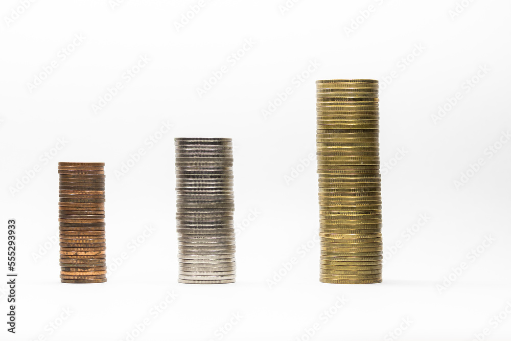 Pile of coins in white background close-up arranged in a row Pile of coins in white background close-up arranged in a row