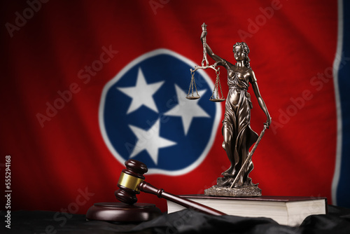Tennessee US state flag with statue of lady justice, constitution and judge hammer on black drapery. Concept of judgement and punishment