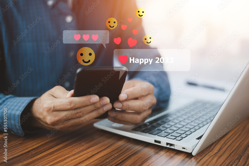 People using mobile smartphone sent message happy 2023 for happy new year concept People using mobile smartphone sent message happy 2023 for happy new year concept