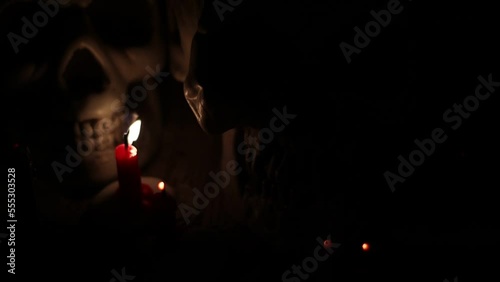 Skull and candlelight at night, religion and belief, magic or ritual