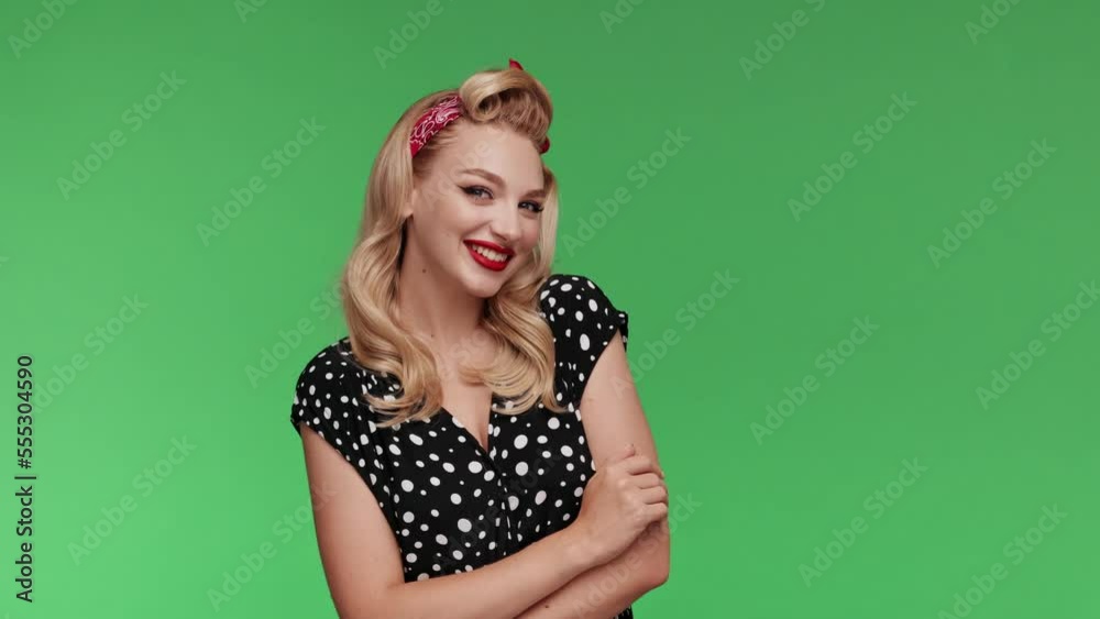 Portrait beautiful retro blond Girl with red lips. Cute Charming woman isolated on a chromakey background in studio Look at the camera and blinking. Retro style. Slow motion. Smiling pin-up Female Portrait beautiful retro blond Girl with red lips. Cute Charming woman isolated on a chromakey background in studio Look at the camera and blinking. Retro style. Slow motion. Smiling pin-up Female