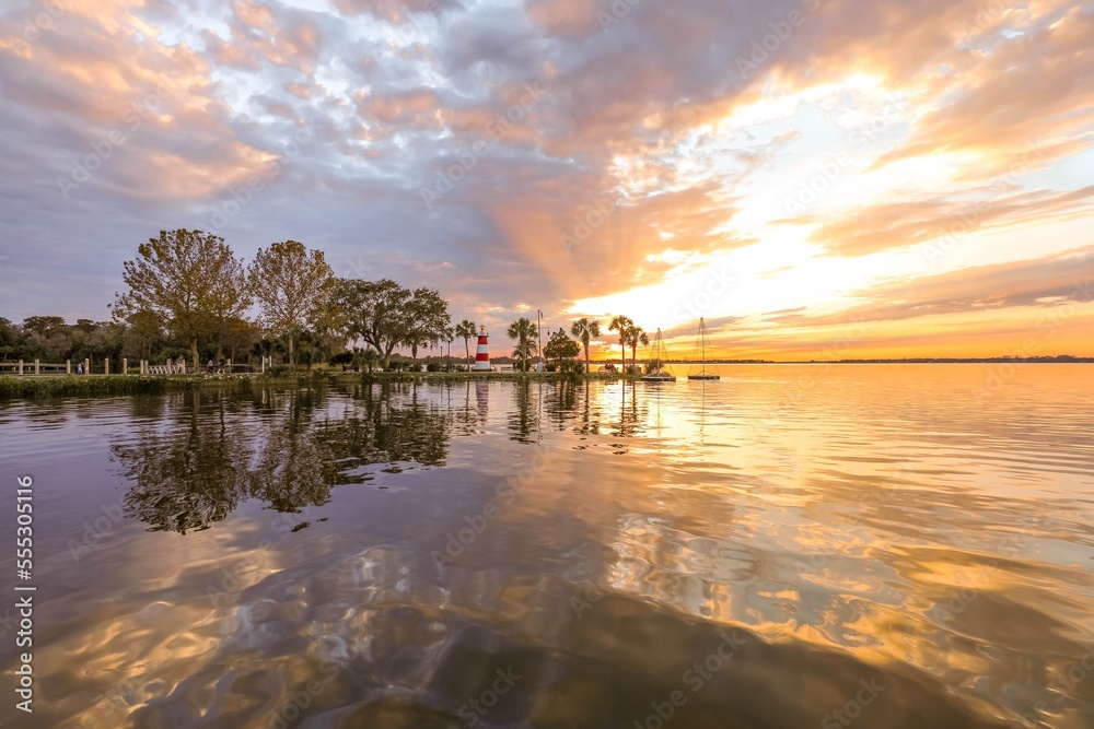 Brilliant sunset shining through clouds over Lake Dora in Florida