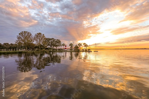 Brilliant sunset shining through clouds over Lake Dora in Florida
