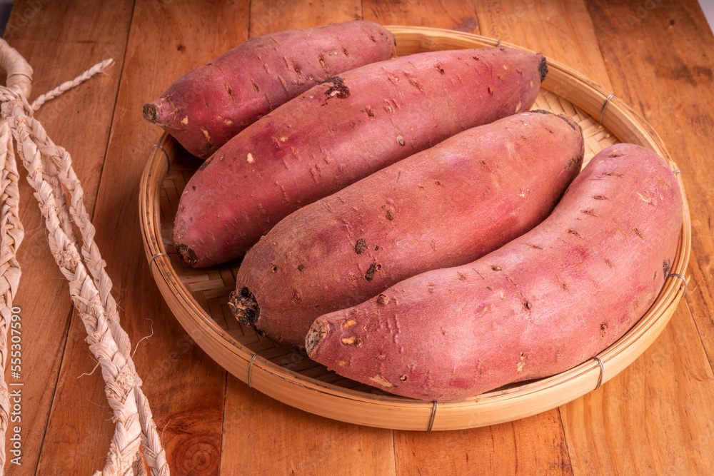 Fresh sweet potato closeup, Japanese Sweet Potato on wooden table. Fresh sweet potato closeup, Japanese Sweet Potato on wooden table.