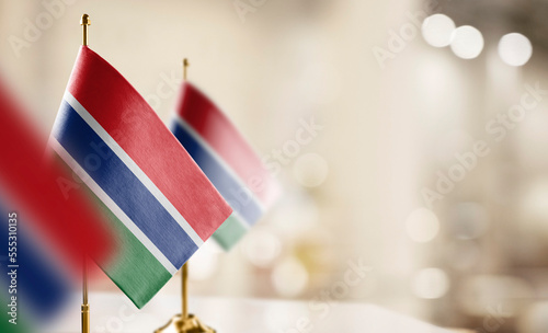 Small flags of the Gambia on an abstract blurry background