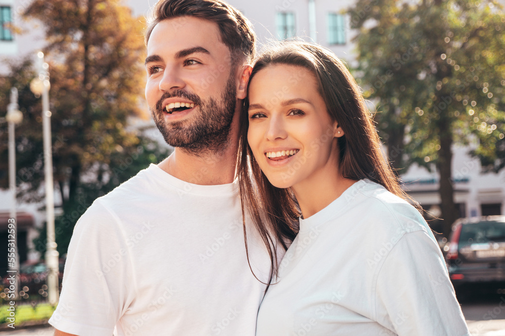 Smiling beautiful woman and her handsome boyfriend. Woman in casual summer jeans clothes. Happy cheerful family. Female having fun. Sexy couple posing in the street at sunny day Smiling beautiful woman and her handsome boyfriend. Woman in casual summer jeans clothes. Happy cheerful family. Female having fun. Sexy couple posing in the street at sunny day