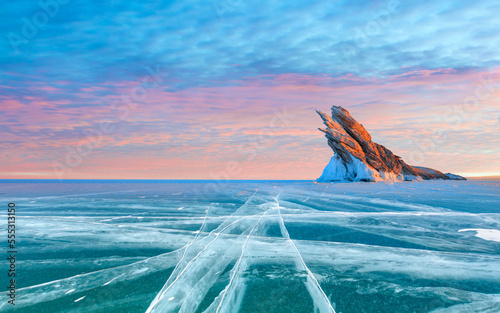 Ogoy island on winter Baikal lake with transparent cracked blue ice at sunrise - Baikal, Siberia, Russia © muratart