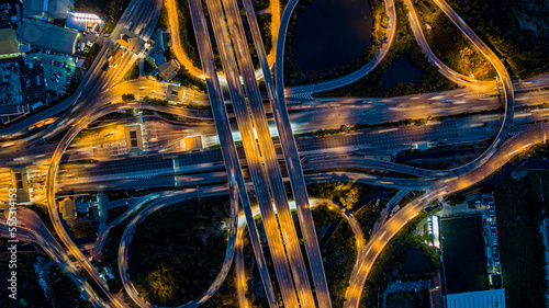 Aerial drone photo of ring road multi level circular junction road, road junction.Aerial view of the transportation,traffic,route and expressway.Night city traffic on 4-way street intersection circle.