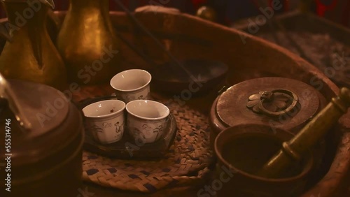 Dubai, UAE - 12th october, 2022: Top view coffee set up three cups and arabic coffee preparation accessories in coffee museum in Dubai photo