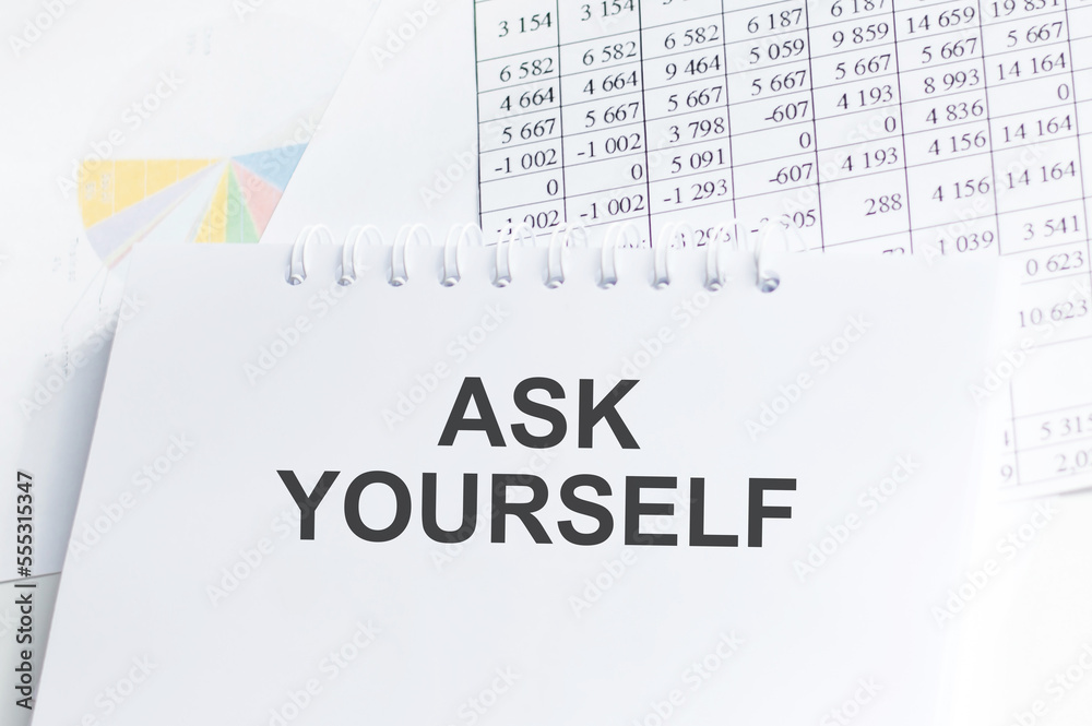 Fototapeta premium ASK YOURSELF text on a paper on the background of documents on the table, business concept
