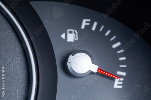 Expensive petrol concept rising cost of living - petrol gauge indicator on empty photo