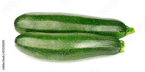Two green zucchini on a white background, close-up. Organic vegetables.