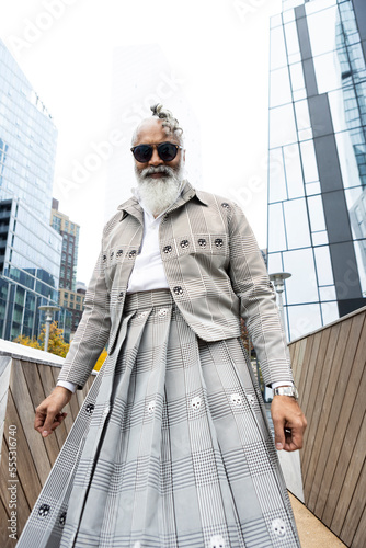 Konstfotografi gray hair bearded man wearing skirt suit in modern city location