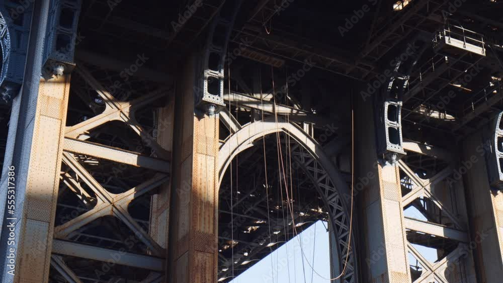 Rusted Steel Beams and hanging ropes underneath Manhattan Bridge, low Angle Rusted Steel Beams and hanging ropes underneath Manhattan Bridge, low Angle