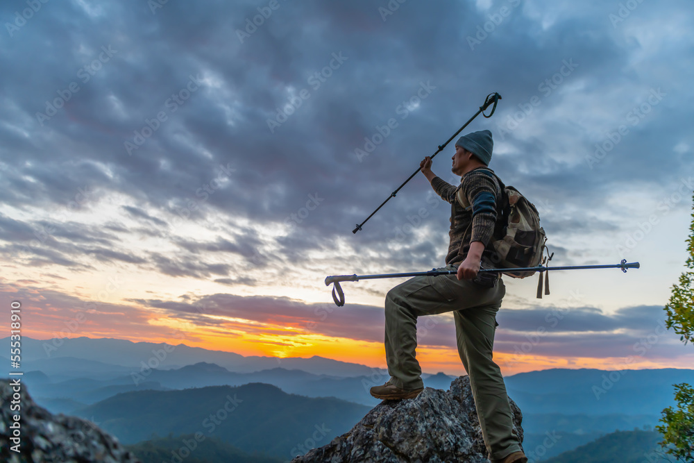 Successful hiker enjoy the view on mountain top cliff edge Successful hiker enjoy the view on mountain top cliff edge