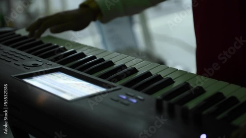 Close-up shot of a musician's fingers playing the keyboard.