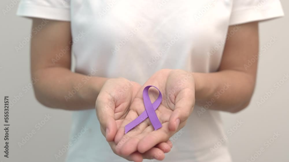 Hand holding purple Ribbon for Pancreatic, Esophageal, Testicular ...