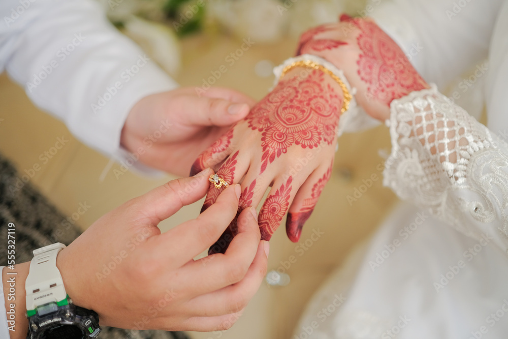 Malay Wedding Couple Putting A Ring On Hand.Selective Focus And Shallow DOF.