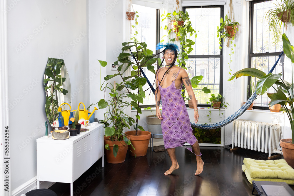 indigenous non-binary artist dancing at home surrounded by house plants indigenous non-binary artist dancing at home surrounded by house plants