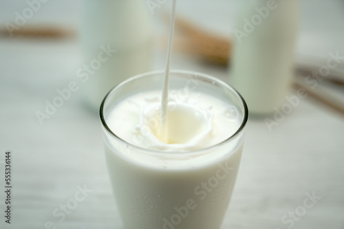 Glass of milk splash and on blue background ,Concept of farm dairy products.