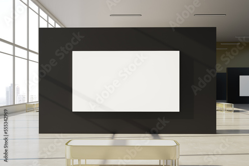 Fototapeta Naklejka Na Ścianę i Meble -  Modern gallery interior with empty white mock up banner on black wall installation, windows with city view and daylight. Museum and exhibition concept. 3D Rendering.