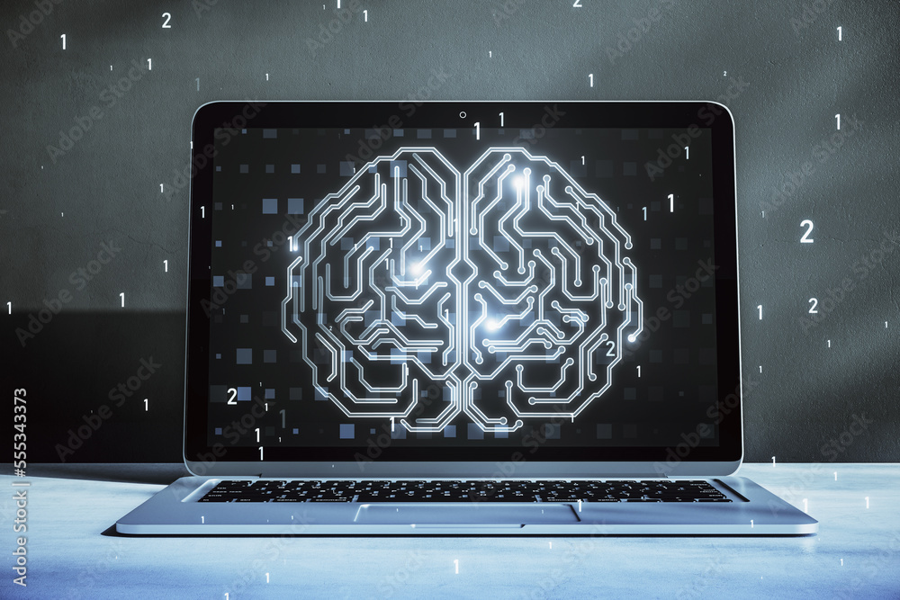 Close up of laptop on desktop with glowing human brain hologram on ...