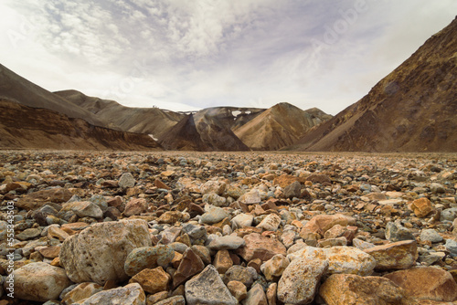 Close up rocks on ground concept photo. Picturesque highland. Front view photography with old mountains on background. High quality picture for wallpaper, travel blog, magazine, article