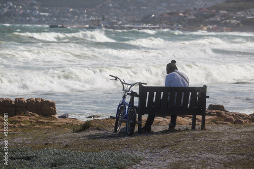 a man with a bicycle on the shore of the Atlantic Ocean. South Africa