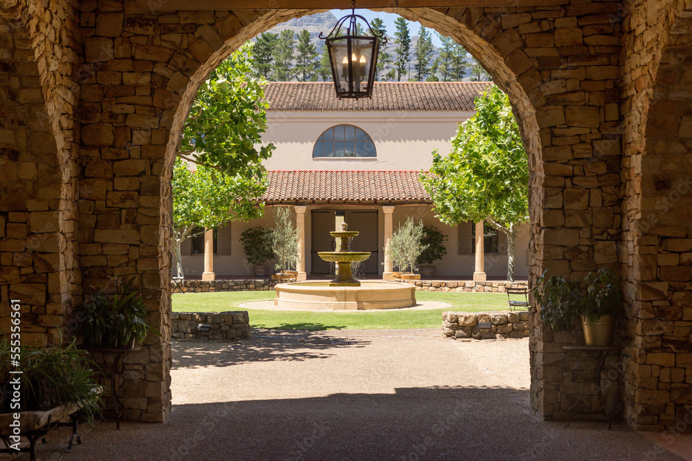 Fototapeta premium arch with a view of the garden and fountain