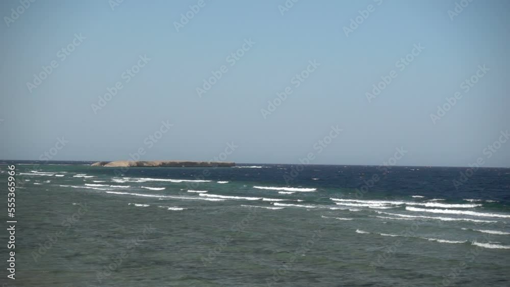 Blue sea waves with white lambs, an island can be seen in the distance. Egypt. Slow motion Blue sea waves with white lambs, an island can be seen in the distance. Egypt. Slow motion