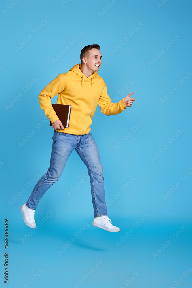 young happy man in casual clothes jumping young happy man in casual clothes jumping