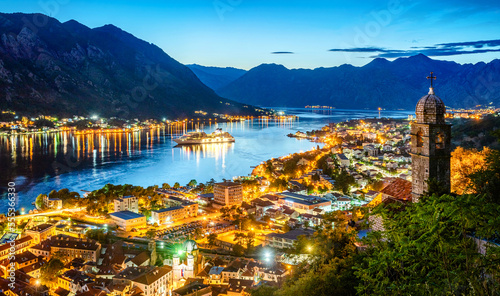 Panoramic evening view of the church, the old town and the Bay of Kotor from above. The Bay of Kotor is the beautiful place on the Adriatic Sea. Kotor, Montenegro. © Tryfonov