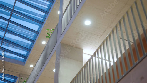 Walk inside a two-story building with interior balcony fence low angle
