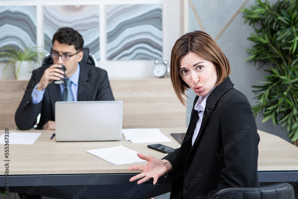 Confused woman in suit feeling stress on interview in the office Confused woman in suit feeling stress on interview in the office