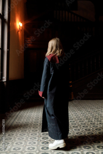 Carpathians, Ukraine, 10/12/2022: children dressed as Harry Potter during the carnival. Halloween costume. Halloween party. A witch with a magic wand. A young student of a magic school casts spells.