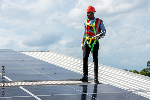 Engineer working setup Solar panel at the roof top. Engineer or worker work on solar panels or solar cells on the roof of business building