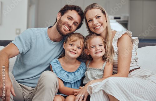 Portrait, mother and father with girls, smile and bonding on sofa for break, quality time and happiness. Love, family and parents with daughters, loving and joy for childcare, mama and dad with kids.