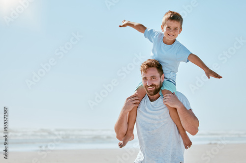 Father, kid and piggy back at beach on vacation, holiday or trip mock up. Family love, care and portrait of man bonding with boy while carrying him on shoulders, having fun and enjoying time together