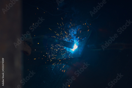 Welder building technical, industrial steel welder in technical workshop, craftsman, industrial steel welder, technical steel in technical factory, Welding of steel, sparking,light color like firework