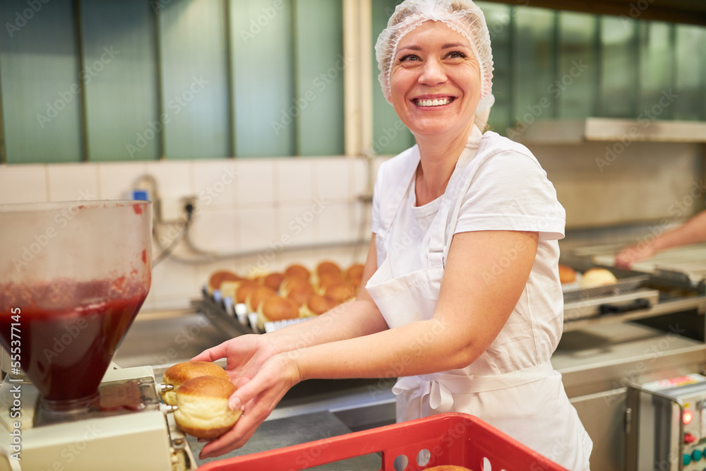 Baker trainee filling pancakes with jam Stock Photo Adobe Stock