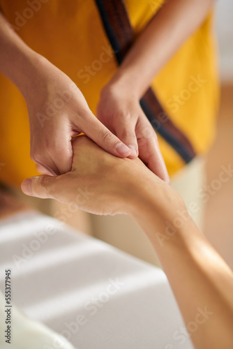 Closeup image of woman receiving hand massage in spa salon