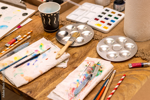Watercolors. Watercolor painting workshop table with brushes and tools.