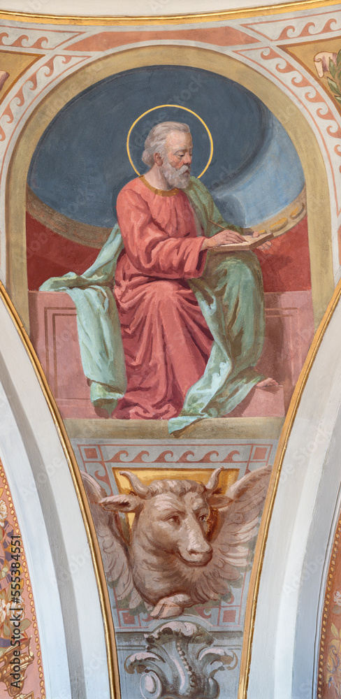 IVREA, ITALY - JULY 15, 2022: The fresco of St. Luke the Evangelist in cupola of church Chiesa di San Salvatore by Giovanni  Silvestro (1914).