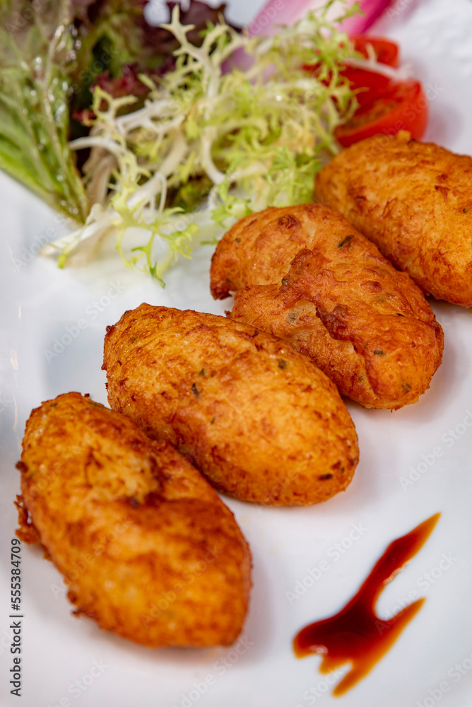 Crispy cod quenelles and fresh green salad