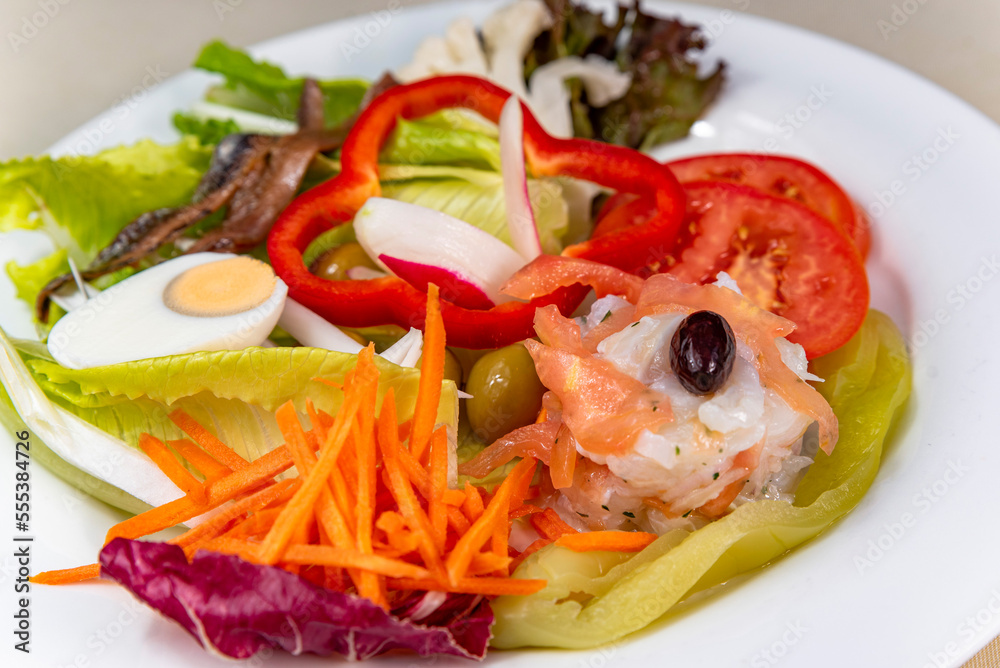 Green salad with cod, anchovies, egg and sweet pepper Green salad with cod, anchovies, egg and sweet pepper